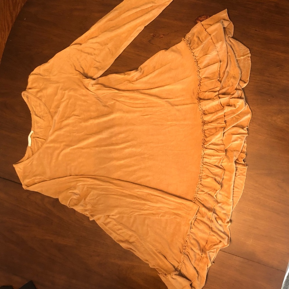 Easel long sleeve tan top with ruffle detail.